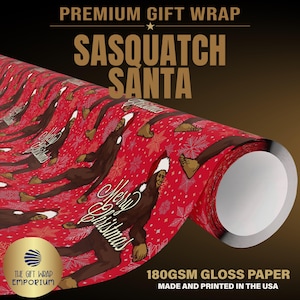 May include: A roll of red gift wrap paper featuring a repeating pattern of brown Sasquatch figures wearing Santa hats and the text Merry Christmas. The paper has a glossy finish and is printed with white snowflakes throughout the design.
