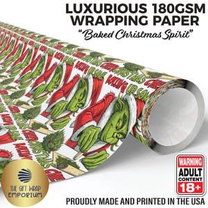 May include: A roll of luxurious wrapping paper with a repeating pattern of a green character in a Santa suit, holding a rolled item. The text "Baked Christmas Spirit" is displayed on the paper. The paper is 180GSM and made in the USA.