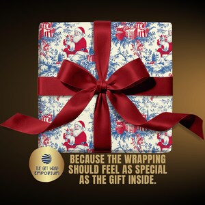 May include: A square gift box wrapped in cream-colored paper featuring a blue and red toile-style pattern of Santa Claus and presents, tied with a wide dark red satin ribbon. Text reads: BECAUSE THE WRAPPING SHOULD FEEL AS SPECIAL AS THE GIFT INSIDE.