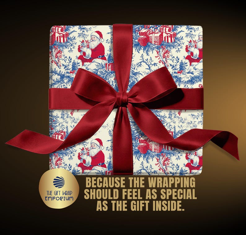 May include: A square gift box wrapped in cream-colored paper featuring a blue and red toile-style pattern of Santa Claus and presents, tied with a wide dark red satin ribbon. Text reads: BECAUSE THE WRAPPING SHOULD FEEL AS SPECIAL AS THE GIFT INSIDE.