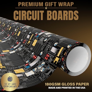 May include: A roll of gift wrap featuring a black and gold circuit board pattern. The text reads PREMIUM GIFT WRAP CIRCUIT BOARDS and 180GSM GLOSS PAPER MADE AND PRINTED IN THE USA. A gold circular logo reads THE GIFT WRAP EMPORIUM.