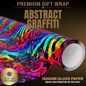 May include: A roll of gift wrap paper featuring a vibrant abstract graffiti pattern with neon pink, blue, yellow, and black colors. The text PREMIUM GIFT WRAP, ABSTRACT GRAFFITI, and 180GSM GLOSS PAPER MADE AND PRINTED IN THE USA are visible.