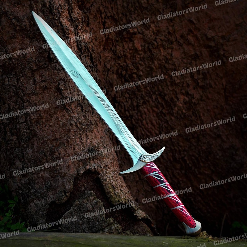 May include: A long, silver sword with a decorative handle. The blade has a light blue hue and a curved design. The handle is red with black and white accents. The sword is displayed against a brown, textured background.