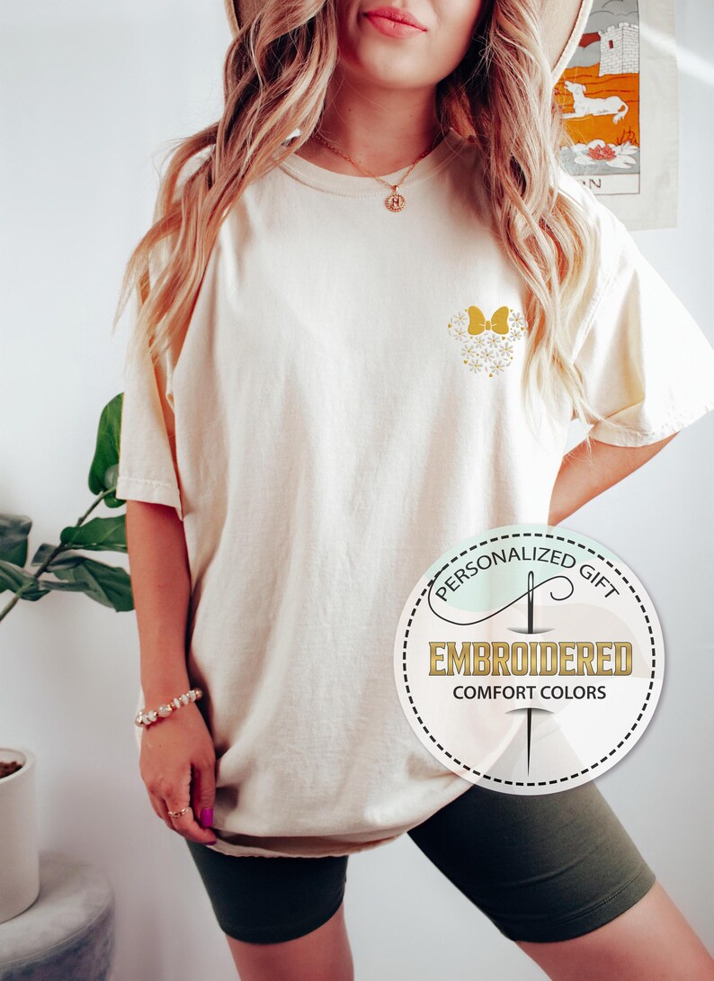 Pu&ograve; includere: Una maglietta color crema con un designo di farfalla ricamata in oro sul petto sinistro. La maglietta &egrave; oversize e ha una vestibilit&agrave; rilassata. Il testo "Regalo personalizzato" e "Ricamato Comfort Colors" &egrave; su un'etichetta circolare.