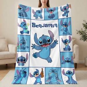 May include: A white and light blue fleece blanket featuring multiple illustrations of the blue character Stitch in various poses. The center of the blanket displays the name Benjamin in bold blue text, surrounded by a grid of Stitch character panels.
