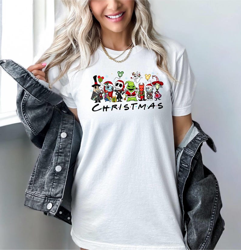 May include: White t-shirt with a graphic of characters from The Nightmare Before Christmas, including Jack Skellington, Sally, and Oogie Boogie. The text "CHRISTMAS" is printed below the characters.