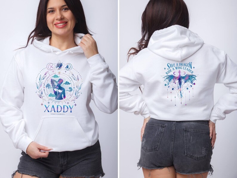 May include: White hoodie with a blue and purple graphic of a person riding a dragon. The text "Save a Dragon, Ride a Wing Leader" is printed on the back of the hoodie. The front of the hoodie has a blue and purple graphic of a person with the text "XADDY" printed below.