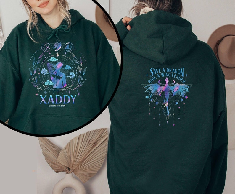 May include: A dark green hoodie with a graphic print of a dragon and the text "Save a Dragon + Ride a Wing Leader" on the back. The front of the hoodie has a graphic print of a person with the text "XADDY - GOLDEN DRAGON -"