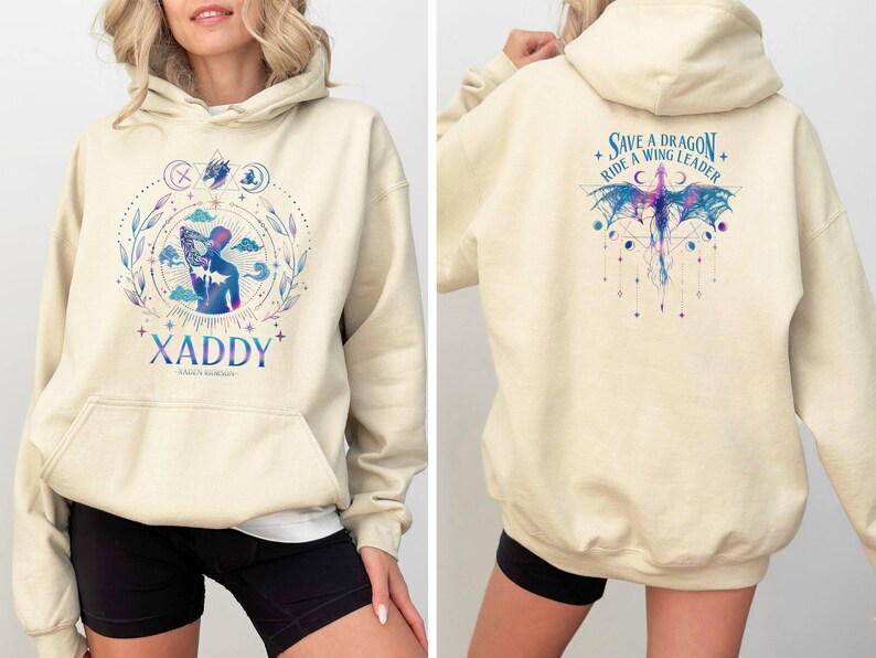 May include: A cream-colored hoodie with a graphic of a person with wings and the text "XADDY" on the front. The back of the hoodie has a graphic of a dragon with the text "Save a Dragon Ride a Wing Leader".