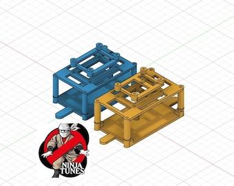 May include: Two 3D-rendered rectangular frames, one blue and one gold, with a layered design. The frames have a base, four legs, and a top section with multiple holes. A logo with a ninja and the text "NINJA TUNES" is in the lower left corner.