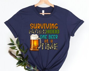 Surviving Fatherhood One Beer At A Time Shirt, Funny Shirt, Fathers Day Shirt, Fathers Day Gift, Gift For Dad, Husband Gift, Fatherhood Tee