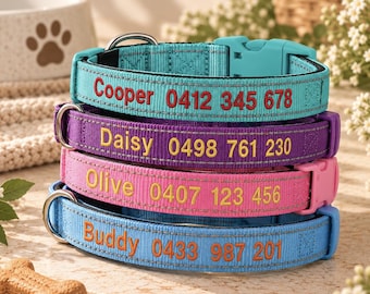 May include: A stack of four nylon dog collars in turquoise, purple, pink, and light blue. Each collar features a plastic buckle, a metal D-ring, reflective stitching, and embroidered names and phone numbers: Cooper 0412 345 678, Daisy 0498 761 230, Olive 0407 123 456, and Buddy 0433 987 201.