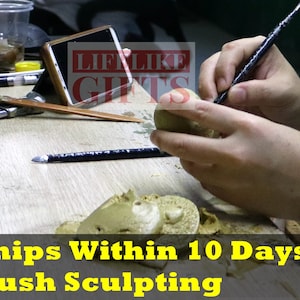 May include: A person's hands are sculpting a small clay figure with a sculpting tool. The clay is a light brown color. The background shows a wooden table with various tools and a cell phone.