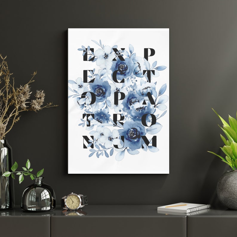 May include: A white canvas print with blue watercolor flowers and the word "EXPECT THE UNEXPECTED" spelled out in black letters.