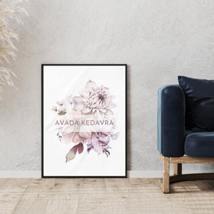 May include: A framed print featuring a watercolor painting of a bouquet of pink and purple flowers. The text "AVADA KEDAVRA" is written in a pink font on the print.