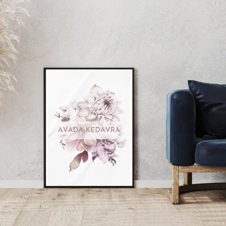 May include: A framed print featuring a watercolor painting of a bouquet of pink and purple flowers. The text "AVADA KEDAVRA" is written in a pink font on the print.