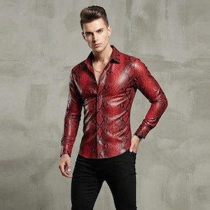 May include: A long-sleeved button-down shirt featuring a vibrant red and black snakeskin pattern. The garment has a classic collar, a front button placket, and fitted cuffs. The material appears to have a smooth, slightly reflective finish.