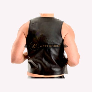 May include: Black leather sleeveless vest with a gold logo that says "Zoefy Leather".