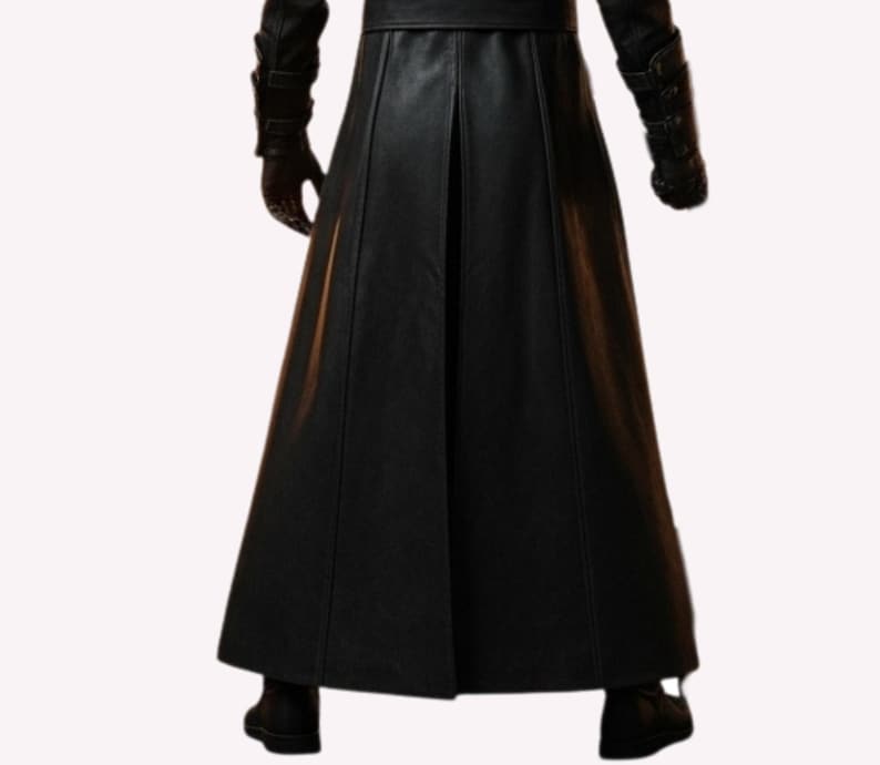 May include: A long, black leather coat with a flared skirt, visible from the waist down. The coat features a center pleat and is paired with black gloves and boots. The image is shot from the waist down.