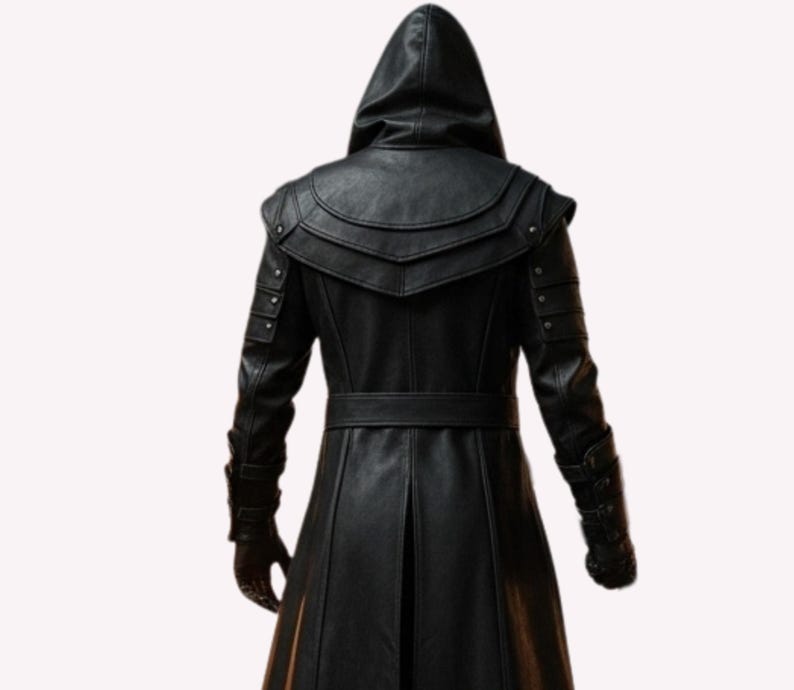 May include: A black leather hooded coat with a belt and decorative shoulder accents. The coat has a long, flowing design and is made of a textured material. The back view shows the intricate details of the garment.