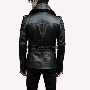 May include: Black leather jacket with a stand-up collar, zipped cuffs, and a belt at the waist. The jacket has decorative shoulder pads with studs and a zipped pocket on the left side. The text "ZOEFY LEATHER" is printed on the back of the jacket.