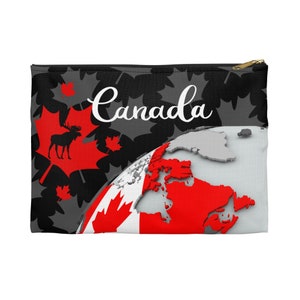 May include: A black and gray zippered pouch with a red and white Canadian flag design. The flag features a stylized globe with Canada highlighted in red. The pouch also features a black moose silhouette on a red maple leaf and the word "Canada" in white cursive.
