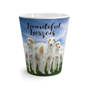 May include: White ceramic mug with a colorful image of four Borzoi dogs standing in a field with a blue sky and white clouds. The text "Beautiful Borzois" is printed on the mug.
