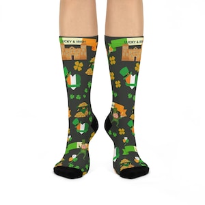 May include: A pair of black socks with a green, orange, and white pattern. The socks feature shamrocks, hearts, leprechauns, and the text "Lucky & Irish".