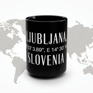 May include: Black ceramic mug with white text that reads "LJUBLJANA, 46° 03' 3.89", E 14° 30' 18" SLOVENIA".