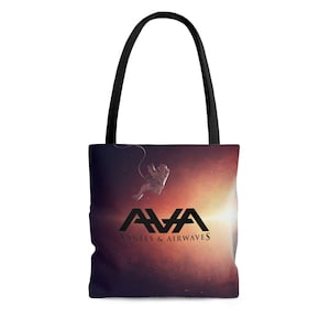 May include: A black tote bag with a colorful galaxy print and a black astronaut floating in the center. The bag has the band name "AVA Angels & Airwaves" printed in black letters.