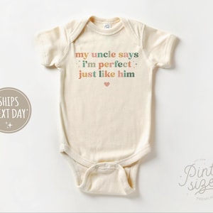 May include: A white baby onesie with the text "my uncle says i'm perfect. just like him" in rainbow colors. A small pink heart is below the text.