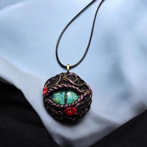 Polymer Clay Dragon Eye pendant or ornament. Hand sculpted dragon eye on a 18 inch cord with 2 in chain extension. Unique gift!