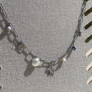 Silver necklace with stainless steel sea shell star charms