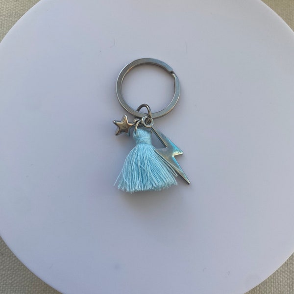 Porte clefs argenté éclair et étoile et pompon bleu