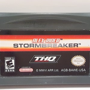 May include: A gray Game Boy Advance game cartridge with a red, black, and white label. The label reads "Alex Rider™ Stormbreaker™" with the THQ logo and an ESRB rating of "Everyone 10+".