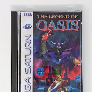 Könnte beinhalten: Ein Sega Saturn Videospiel-Etui mit blauem und violettem Hintergrund. Das Spiel heißt "The Legend of Oasis" und zeigt eine große, gehörnte, violette dämonenartige Figur mit einem schwert schwingenden Krieger im Vordergrund. Das Spiel ist von der ESRB mit "KA" bewertet.
