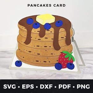 May include: A digital cut file for a card featuring a stack of pancakes with chocolate syrup, butter, and blueberries. The card is designed to be cut out and assembled.