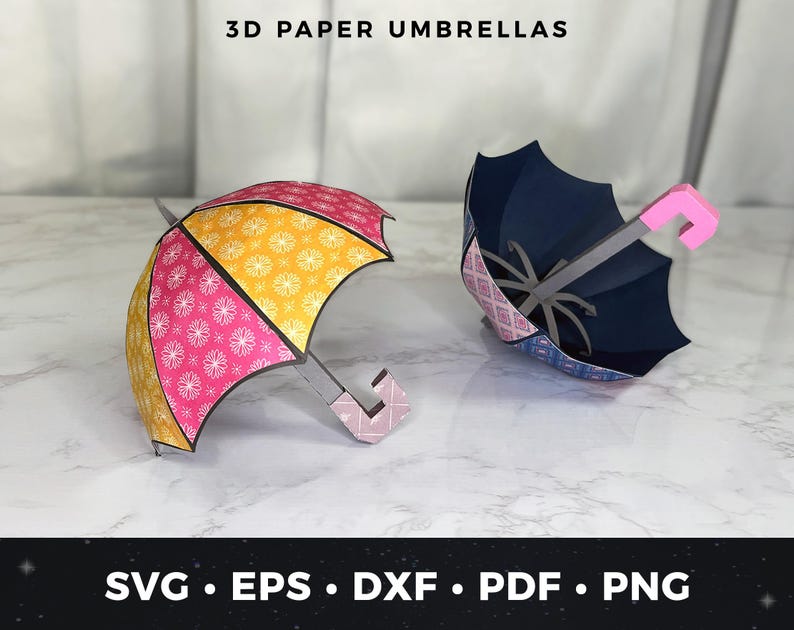 May include: Two 3D paper umbrellas, one pink and yellow with a white floral pattern and one blue with a pink and white floral pattern.  The umbrellas are on a white surface.  SVG, EPS, DXF, PDF, PNG.