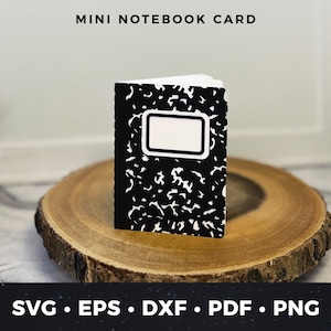 May include: A black and white mini notebook card with a blank label. The card is sitting on a wooden surface. MINI NOTEBOOK CARD is written at the top of the image.