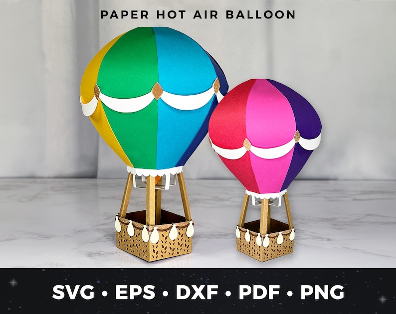 Puede incluir: Dos globos aerost&aacute;ticos de papel. Uno es una vibrante mezcla de amarillo, verde, azul y blanco. El otro es rojo, rosa y morado. Ambos tienen una base de cesta y el texto "PAPER HOT AIR BALLOON" en la parte superior. El texto inferior dice "SVG &bull; EPS &bull; DXF &bull; PDF &bull; PNG".
