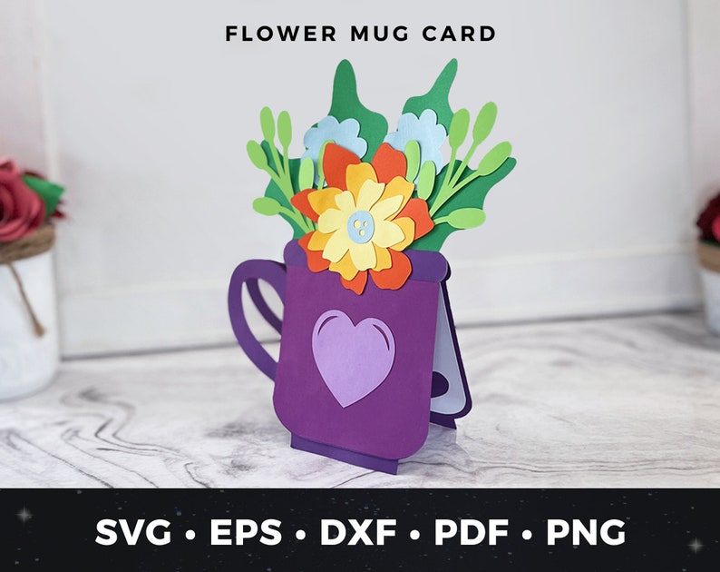 May include: A purple mug card with a flower bouquet inside. The flowers are red, yellow, blue, and green. The card says "FLOWER MUG CARD" at the top. The card is for cutting and crafting.