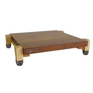 May include: A wooden audio equipment platform with a rectangular top and four legs. The top is a dark brown color, and the legs are a lighter wood. The platform has the text "rigidrack" on the front.