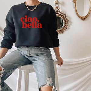 May include: Black sweatshirt with red text that says "ciao, bella".