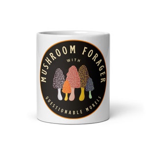 May include: White ceramic mug with a black circle design featuring the text "Mushroom Forager with Questionable Morels". The circle design includes a group of five colourful mushrooms.