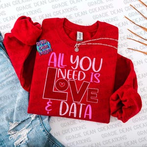 May include: Red sweatshirt with the text "All you need is love & data" in pink and white lettering. A small pink heart is included in the word "love".