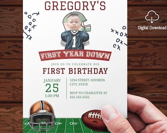 Op de afbeelding: Een witte en rode voetbal-thema eerste verjaardagsinvitation met een foto van een babyjongen die een voetbaltrui draagt. De uitnodiging zegt "Gregory's First Year Down" en bevat de datum, tijd en adres voor het feest.