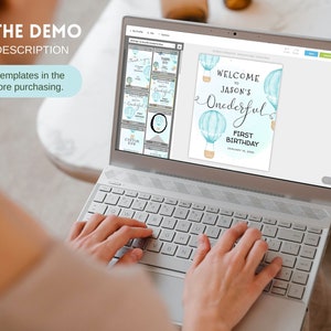 May include: A laptop screen displaying a digital design template for a first birthday party. The design features blue and white hot air balloons with the text "Welcome to Jason's Onederful First Birthday".