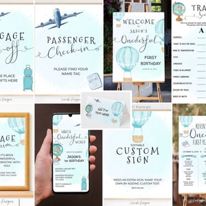 May include: A set of printable signs for a first birthday party with a travel theme. The signs feature blue and white hot air balloons, airplanes, and luggage. The signs include "Welcome to Jason's Onederful First Birthday", "Luggage Drop-off", "Passenger Check-in", "Baggage Claim", "What a Onederful World", "Editable Custom Sign", and "Travel Scattergories".