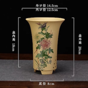 May include: A beige ceramic planter with a flared rim and three feet, featuring a floral print of chrysanthemums. Dimensions are 14.5 cm outer diameter, 12.5 cm inner diameter, 18 cm inner height, 20 cm outer height, and 8 cm base diameter.