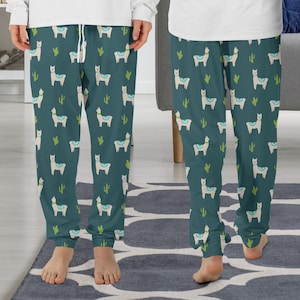May include: Teal blue pajama pants with a white llama and cactus pattern.